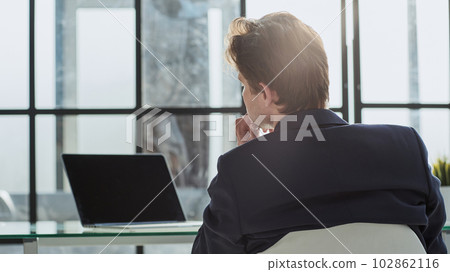 Rear back view portrait businessman sitting at desk at workplace 102862116