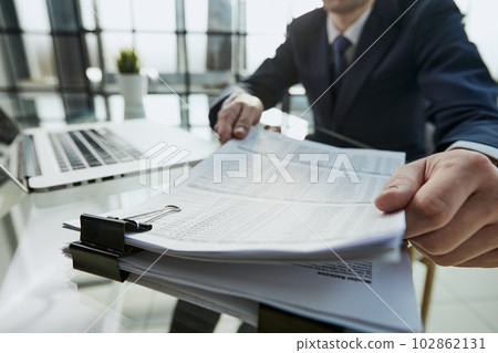 Close-up Of A Businessman Analyzing Financial Report Close-up Of A Businessman Analyzing Financial Report 102862131
