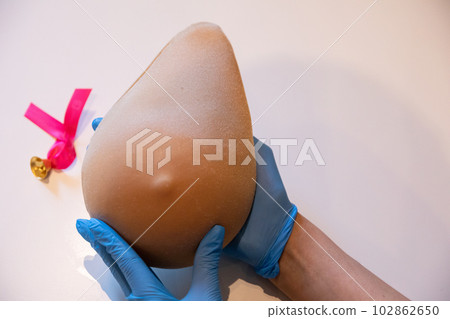 Instructions on how to compress the breast with one hand while banging on the Lady M phantom. 102862650