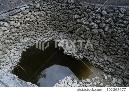 Deep brick wells, disused pumping wells, dark wells of coral, decaying masonry springs, 102862677