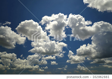White puffy cumulus clouds on summer blue sky White puffy cumulus clouds on summer blue sky 102862881