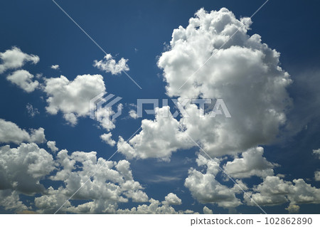 White puffy cumulus clouds on summer blue sky 102862890