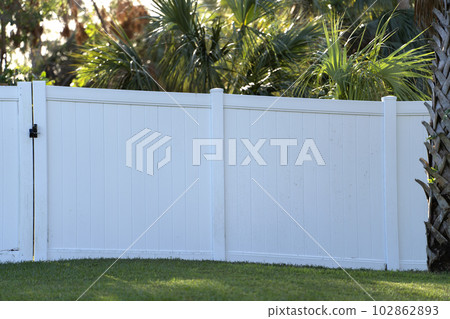 White plastic fence for back yard protection and privacy 102862893