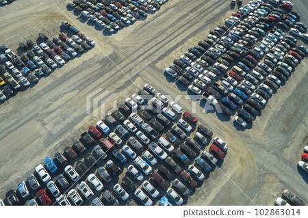 View from above of big parking lot with parked used cars after accident ready for sale. Auction reseller company selling secondhand broken vehicles for repair View from above of big parking lot with parked used cars after accident ready for sale. Auction reseller company selling secondhand broken vehicles for repair 102863014