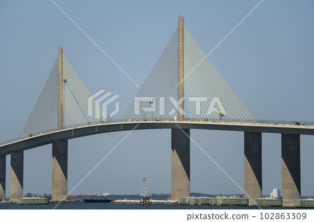 Sunshine Skyway Bridge over Tampa Bay in Florida with moving traffic. Concept of transportation infrastructure Sunshine Skyway Bridge over Tampa Bay in Florida with moving traffic. Concept of transportation infrastructure 102863309