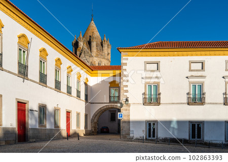 Pousada hotel convent in the old town of Evora with buildings painted in white and yellow and ceramic tiled roofs 102863393