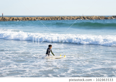 A little boy surfer in the sea A little boy surfer in the sea 102863533