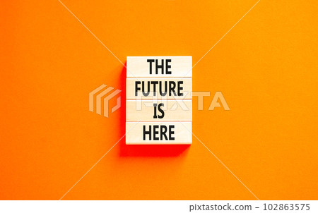 The future is here symbol. Concept words The future is here on wooden block. Beautiful orange table orange background. Motivational business the future is here concept. Copy space. 102863575