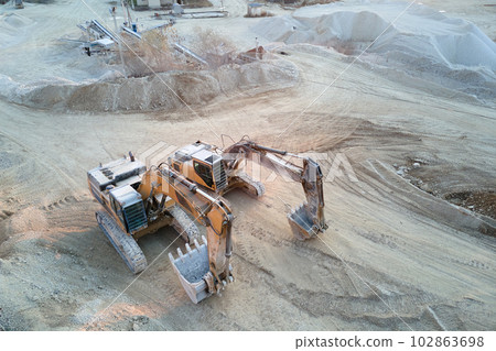 Open pit mining site of construction sand stone materials with excavator equipment for digging of gravel resources at quarry Open pit mining site of construction sand stone materials with excavator equipment for digging of gravel resources at quarry 102863698