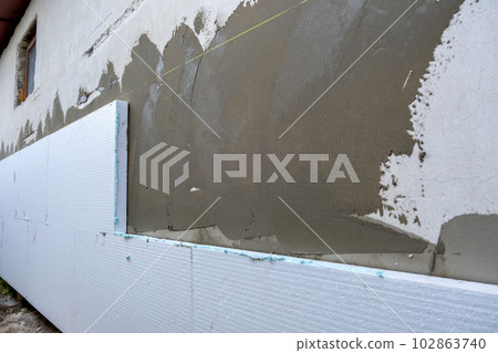 Insulation of facade wall with styrofoam sheets. Polystyrene insulation  boards with glue adhesive Stock Photo by bilanol