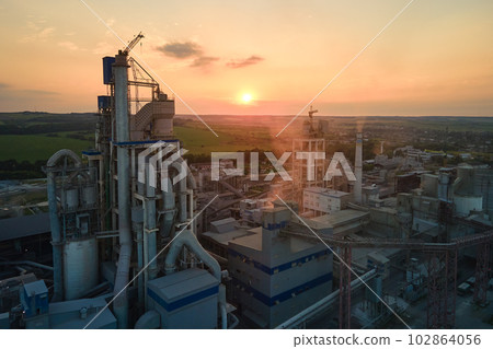 Cement plant with high factory structure and tower cranes at industrial production area. Manufacture and global industry concept 102864056