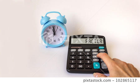 Text factor on calculator and clock on white background Text factor on calculator and clock on white background 102865117