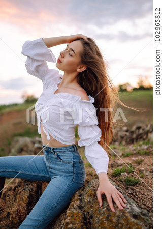 Young cheerful woman wearing cowgirl boots posing in the countryside. Fashion, style, lifestyle concept 102865812