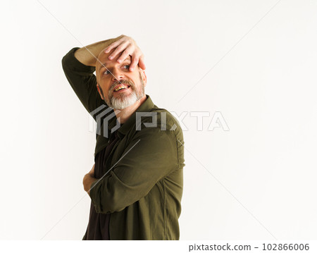 Concept of middle age crisis. Senior man standing against white wall. Mid aged man in pensive pose and looks into future, contemplating uncertainties and challenges that come with life transitions Concept of middle age crisis. Senior man standing against white wall. Mid aged man in pensive pose and looks into future, contemplating uncertainties and challenges that come with life transitions 102866006