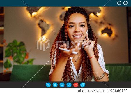 Headshot portrait screen view of young African American woman sit at home talk on video. 102866191