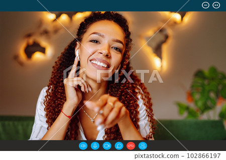 Headshot portrait screen view of young African American woman sit at home talk on video. 102866197