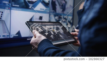 Security operator zoom CCTV cameras using tablet Security operator zoom CCTV cameras using tablet 102866327