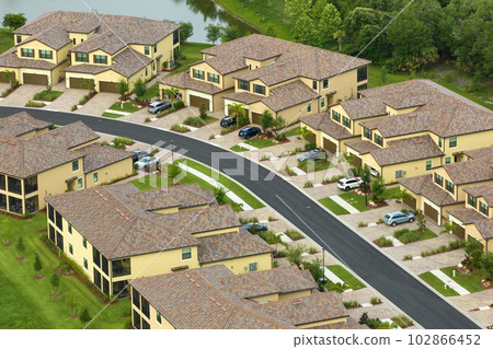 Aerial view of tightly located family houses in Florida closed suburban area. Real estate development in american suburbs 102866452