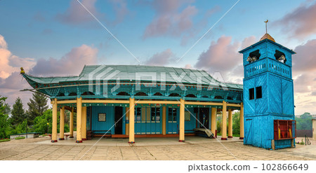 Karakol, Kyrgyzstan - May 2022: Dungan Mosque in Karakol is a unique architectural masterpiece built by Chinese Muslims. Its colorful exterior and intricate details are a must-see. Karakol, Kyrgyzstan - May 2022: Dungan Mosque in Karakol is a unique architectural masterpiece built by Chinese Muslims. Its colorful exterior and intricate details are a must-see. 102866649