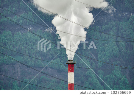 White smoke from the chimney of a manufacturing plant. 102866699