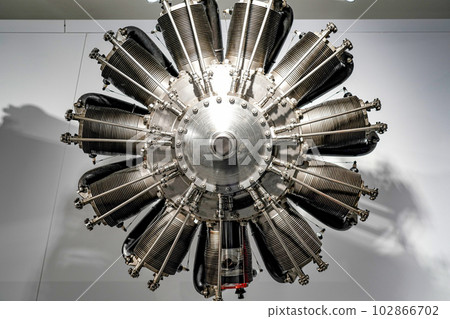 Twelve-cylinder engine of an old-style aircraft in a museum showcase. 102866702
