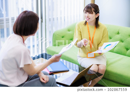A woman having a meeting while looking at materials 102867559