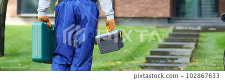 Cropped shot of builder carrying toolbox at cottage construction site 102867633