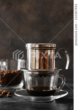 Traditional method of making vietnamese coffee with condensed milk. Traditional method of making vietnamese coffee with condensed milk. 102867691