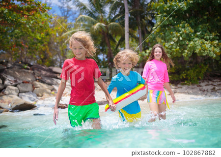Kids playing on tropical beach. Summer fun. Kids playing on tropical beach. Summer fun. 102867882