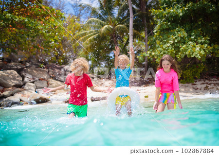 Kids playing on tropical beach. Summer fun. Kids playing on tropical beach. Summer fun. 102867884