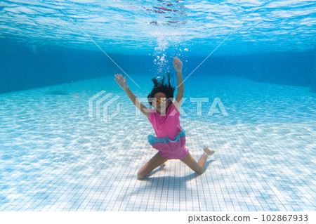 Child in swimming pool on ring toy. Kids swim. Child in swimming pool on ring toy. Kids swim. 102867933