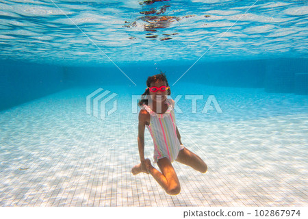 Child in swimming pool on ring toy. Kids swim. Child in swimming pool on ring toy. Kids swim. 102867974