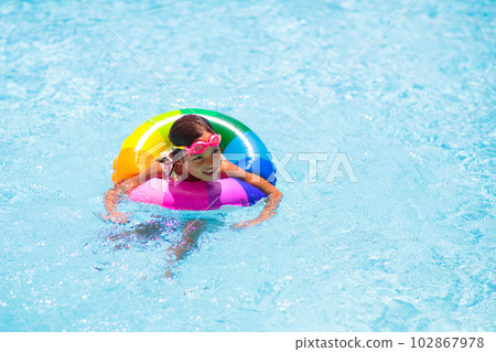 Child in swimming pool on toy ring. Kids swim. Child in swimming pool on toy ring. Kids swim. 102867978