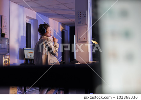 Positive corporate worker listening punk music in startup office, enjoying work break. Playfyl businesswoman working overhours at financial strategy, having fun and dancing late at night Positive corporate worker listening punk music in startup office, enjoying work break. Playfyl businesswoman working overhours at financial strategy, having fun and dancing late at night 102868336