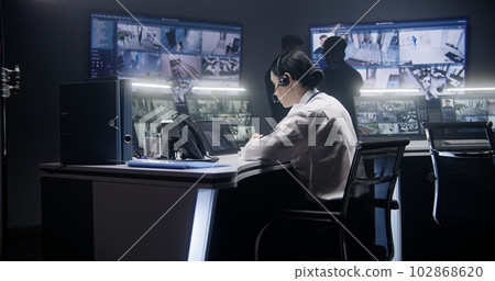 Female officer controls CCTV cameras using tablet Female officer controls CCTV cameras using tablet 102868620