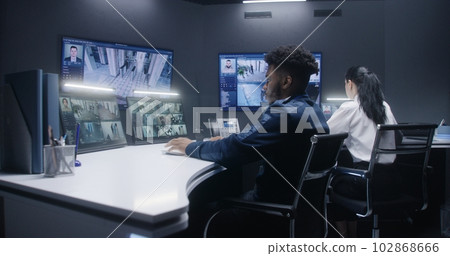 Multi ethnic security operators control cameras Multi ethnic security operators control cameras 102868666