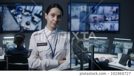 Portrait of female security worker looking at camera Portrait of female security worker looking at camera 102868727