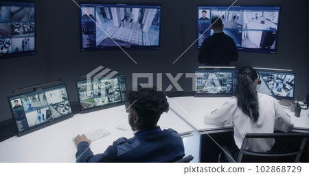 Security officers work in surveillance center Security officers work in surveillance center 102868729