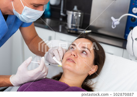 Woman getting cosmetic facial injection in clinic Woman getting cosmetic facial injection in clinic 102870887