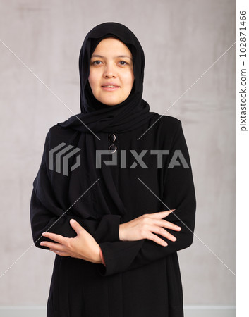 Positive young muslim woman wearing a hijab looking at camera studio Positive young muslim woman wearing a hijab looking at camera studio 102871466