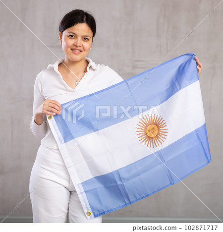 Young woman posing in studio with Argentina flag 102871717