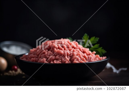 food background. Raw ground beef ready to be cooked on a plate 102872087