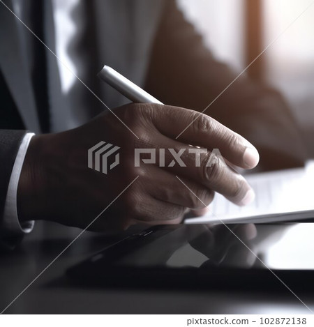 close-up of a hand with a stylus and a tablet 102872138