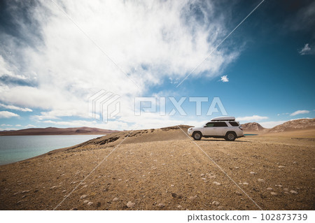 Driving off road car on the high altitude landside mountains Driving off road car on the high altitude landside mountains 102873739