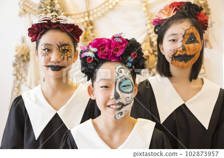 Elementary school girls with face paint Halloween makeup 102873957