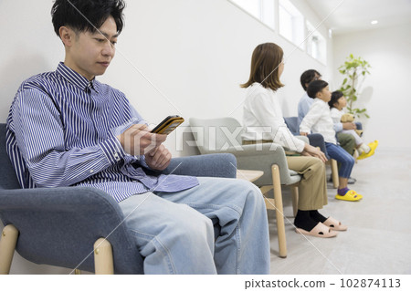 Dentist, men and parents waiting in the waiting room of the clinic Dentist, men and parents waiting in the waiting room of the clinic 102874113