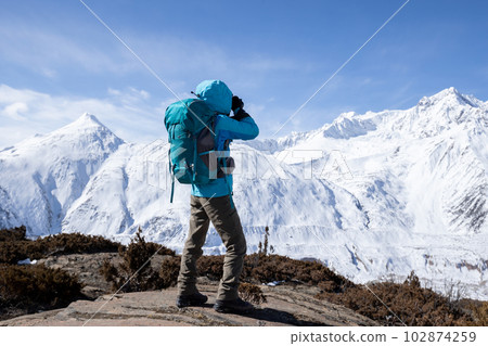 Woman hiker hiking in winter hugh glacier mountain,China 102874259