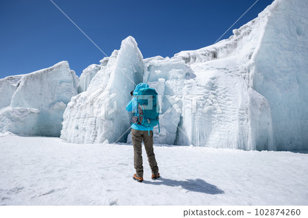 Woman hiker hiking in winter hugh glacier mountain,China 102874260