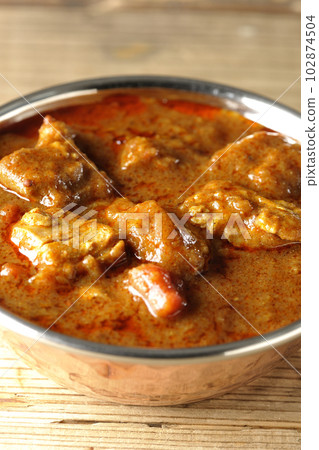 Spicy Indian curry with chicken 102874504