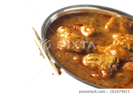 Spicy Indian curry with chicken shot on white background Spicy Indian curry with chicken shot on white background 102874651